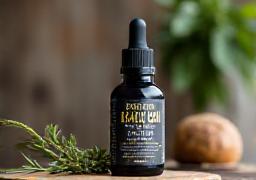 Natural eco-friendly beard oil displayed on a wooden shelf